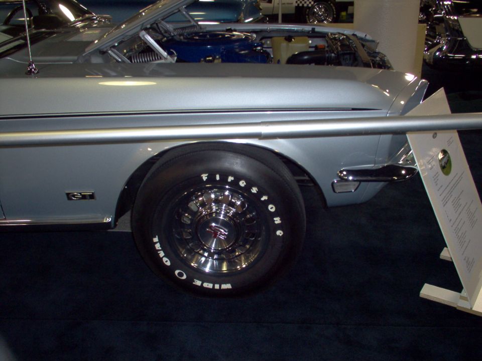 Silver 1970 Ford Ranchero GT with hood open, showing engine and wide oval tires