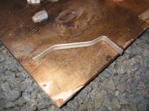 1991 Ford Explorer - Lug wrench and lug nuts are placed on a wooden surface with gravel in the background.