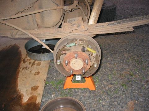 1991 Ford Explorer - Close-up of a vehicle's rear drum brake assembly, supported by an orange jack stand.