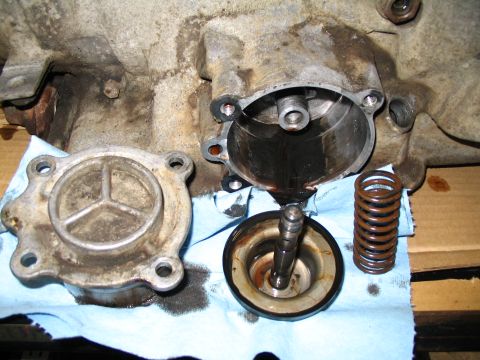 1984 Ford Bronco - Close-up of a disassembled automatic transmission component, showing internal parts and housing.