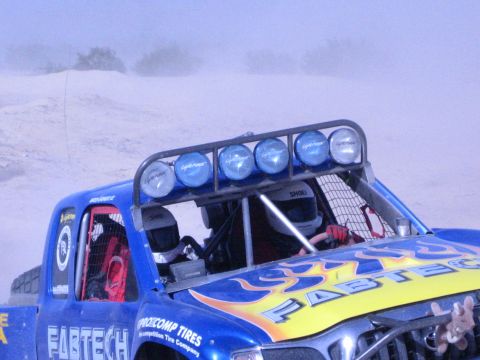 Close view of a blue Fabtech off-road race truck's light bar and cockpit