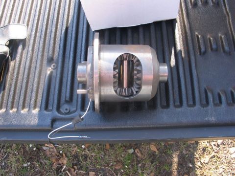 1995 Ford Bronco - A close-up view of a differential locker, showing its internal gears and wiring, placed on a truck's tailgate.