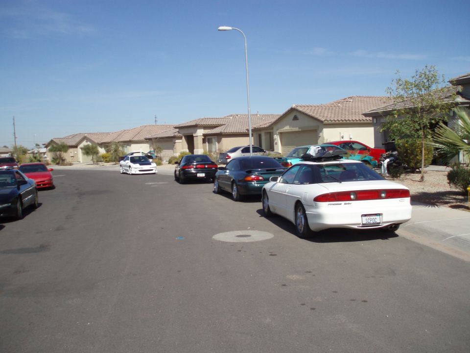 White Ford Probe coupe parked along a suburban desert street