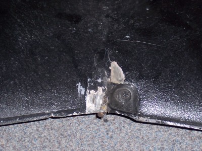1972 Ford Ranchero - A close-up view of a vehicle's body panel reveals a mounting point with signs of wear and tear.