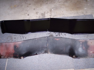 1972 Ford Ranchero - Two painted and two unpainted car bumper sections laid out on a floor.