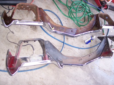 1972 Ford Ranchero - Two front bumper assemblies, one with a red taillight, are laid out on a concrete floor.