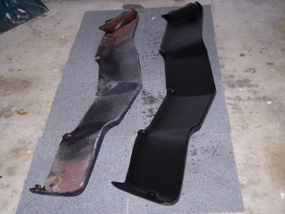 1972 Ford Ranchero - Two car fender sections are laid out on a mat, one showing rust and the other painted black.