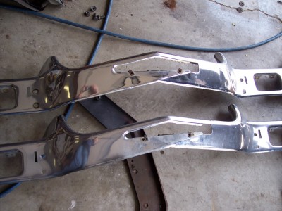 1972 Ford Ranchero - Two chrome bumper sections, likely for a classic car or truck, are shown laid out on a concrete floor.