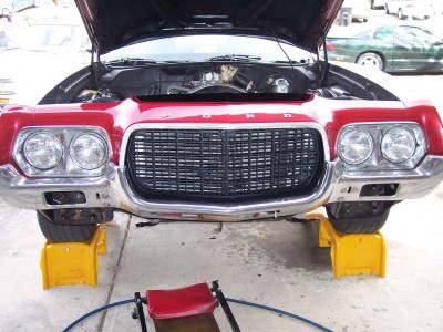1972 Ford Ranchero - Front view of a 1972 Ford Ranchero with its hood open, raised on yellow jack stands.