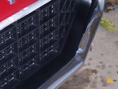 1972 Ford Ranchero - Close-up of the front grille and bumper of a 1972 Ford Ranchero, showing damage to the bumper.