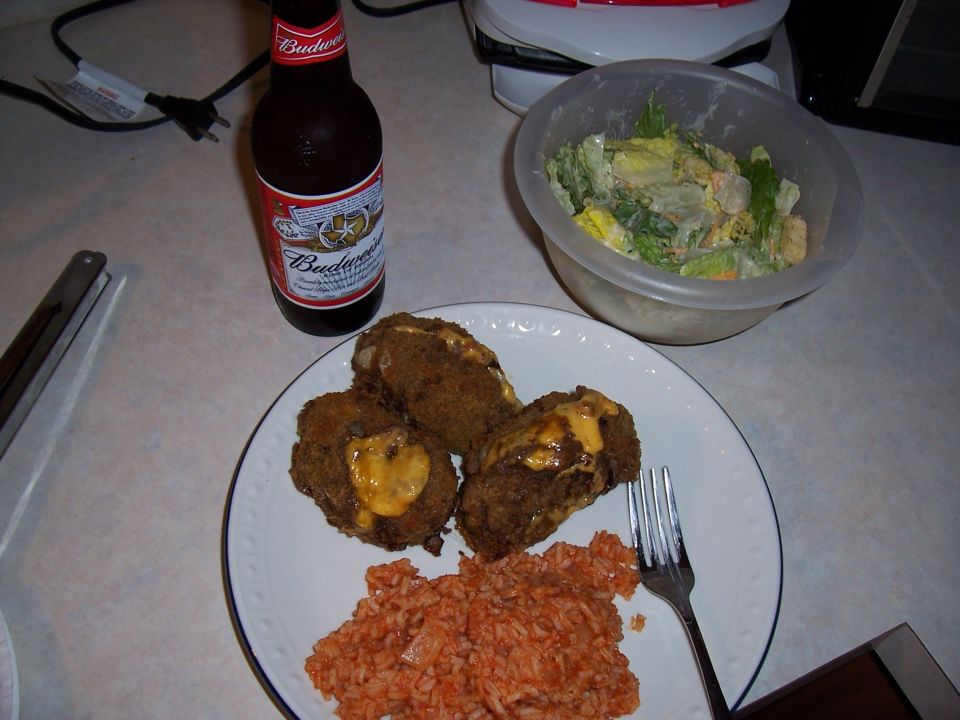 Plate of fried food with cheese, rice, salad, and a bottle of Budweiser beer