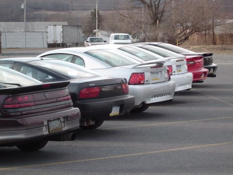 2002 Chevrolet Camaro - Several cars are parked in a lot, viewed from the rear.