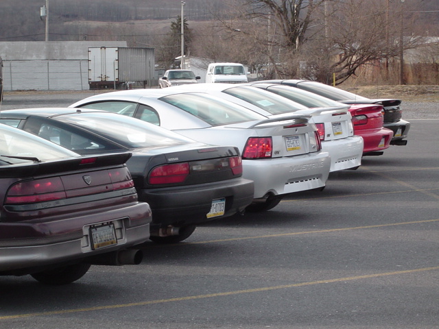 Silver Ford Mustang with a spoiler and a license plate