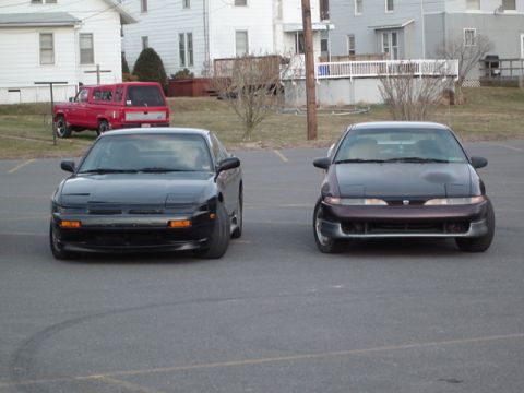 2002 Chevrolet Camaro - A black Nissan 240SX and a dark purple Mitsubishi Eclipse are parked side-by-side in an outdoor lot.
