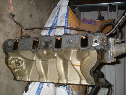 1993 Ford Bronco - Engine intake manifold, likely from a Ford vehicle, shown in a workshop setting.