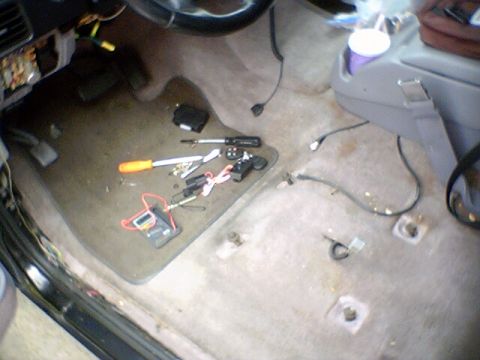 1994 Ford Bronco - The interior of a car shows tools and wiring scattered on the floor, indicating recent work.