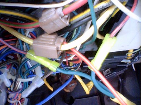 1994 Ford Bronco - A complex tangle of vehicle wiring harnesses, connectors, and wires is visible.