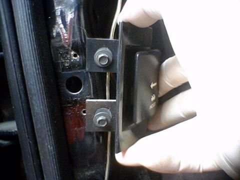 1994 Ford Bronco - Door latch mechanism with 'HOOD' text and arrow being installed.