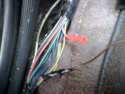 1994 Ford Bronco - Close-up of a vehicle's wiring harness, showing various colored wires and a red connector.