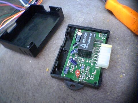 1994 Ford Bronco - An electronic control module is disassembled, revealing its internal circuitry and components.