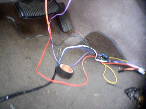 1994 Ford Bronco - A tangle of wires and electrical components are visible on the floor of a vehicle's interior.