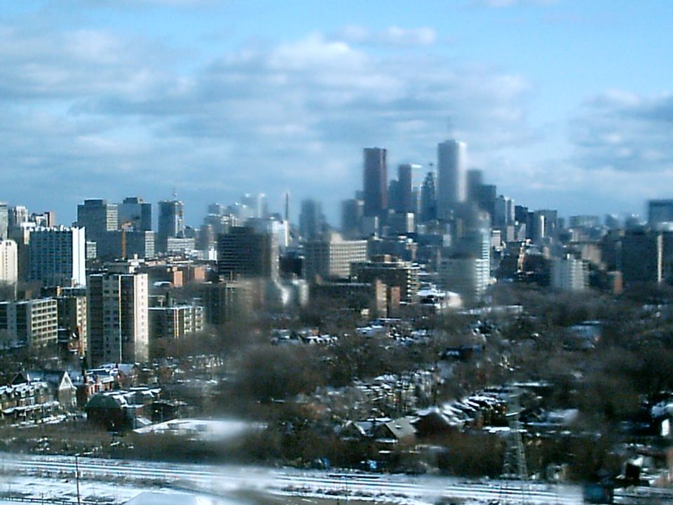 Toronto skyline with snow on the ground and cloudy sky