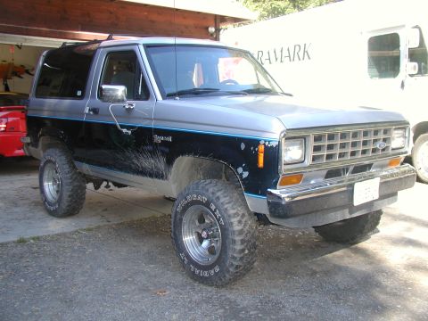 1987 Ford Bronco II - This 1987 Ford Bronco II features a two-tone silver and black paint scheme and aggressive off-road tires.