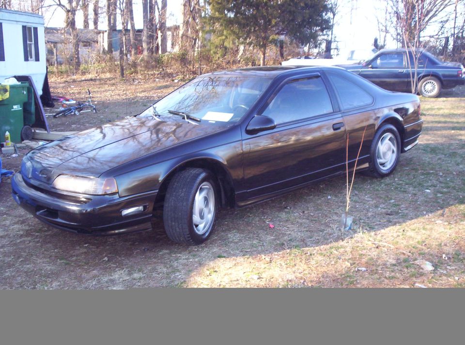 Black 1989 Ford Thunderbird parked outside with another car in the background