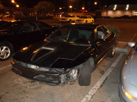 1997 Ford Probe - Black 1997 Ford Probe missing its front bumper, seen at a night meet.