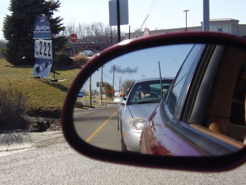 1997 Ford Taurus - A silver sedan is seen in the side mirror of another vehicle, with a Pepsi sign visible on the left.