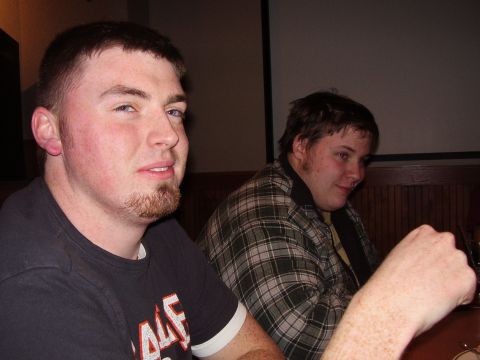 1997 Ford Taurus - Two men are seated at a table, with one in the foreground looking towards the camera.