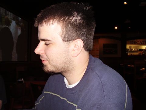 1997 Ford Taurus - A man is seen in profile, looking to the left, with a dark background.