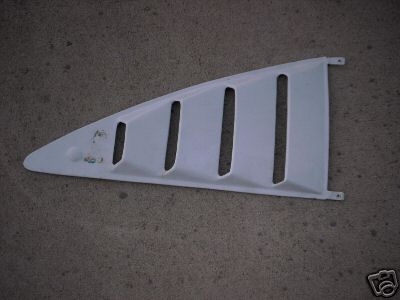 1978 Ford Mustang II - A white plastic vent window louvre with multiple vertical slots is shown against a textured background.