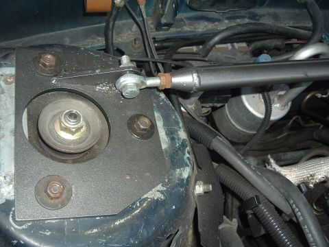 1993 Ford Taurus - This image shows a close-up view of a vehicle's suspension components, specifically a strut mount and sway bar link.