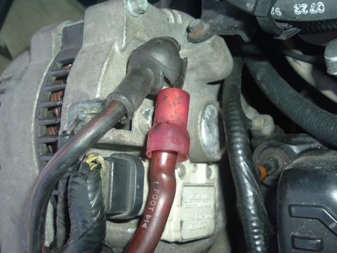 1993 Ford Taurus - Close-up view of automotive wiring connected to an alternator, with visible text on a wire.