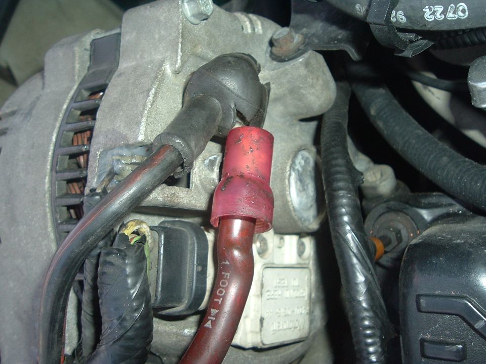 Alternator wiring with red crimp connector and black protective sleeve. Text "1 FOOT" visible on wire