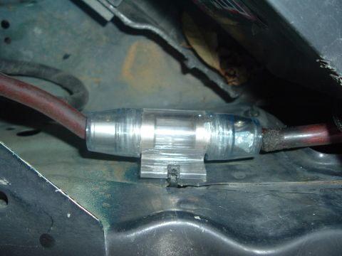 1993 Ford Taurus - Inline fuse holder with red wire, likely part of an aftermarket electrical modification.
