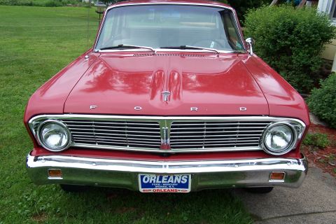 1965 Ford Falcon - Front view of a red 1965 Ford Falcon with a chrome grille and bumper.