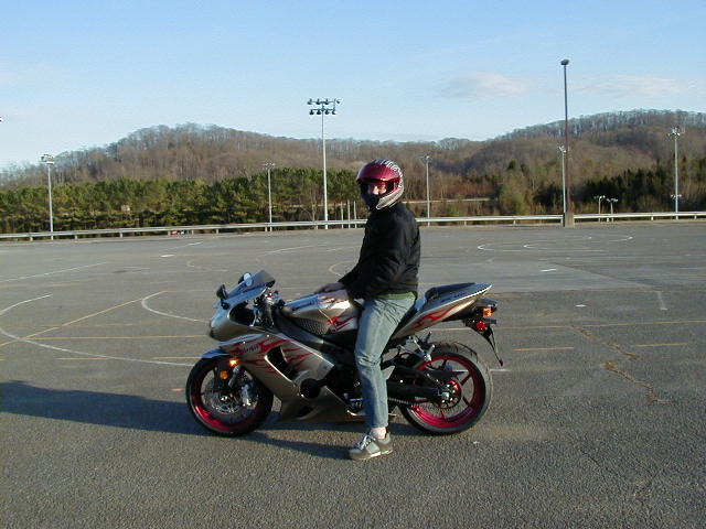 2006 Kawasaki Ninja motorcycle with rider in a parking lot