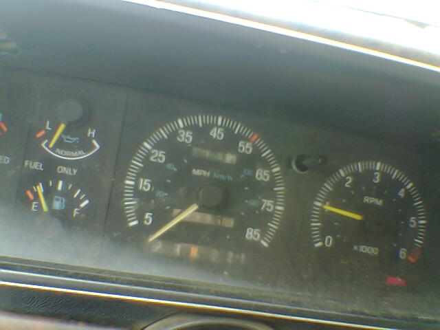 Speedometer, fuel gauge, and tachometer on a vehicle dashboard