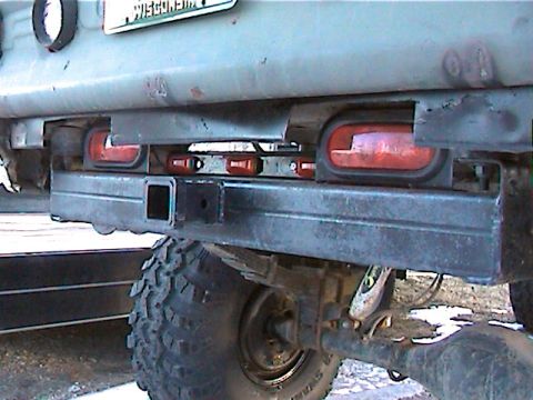 1977 Ford F-150 - Close-up view of the rear bumper and tire assembly on a truck, with a Wisconsin license plate visible.