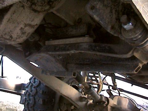 1977 Ford F-150 - Close-up of a vehicle's undercarriage, focusing on suspension and tire details.