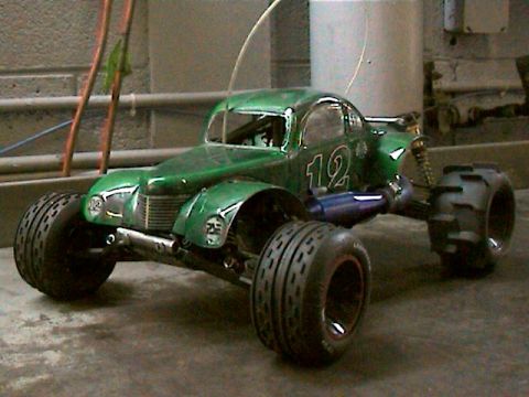 1977 Ford F-150 - This green remote control car features off-road tires and a prominent number 12 graphic on its body.
