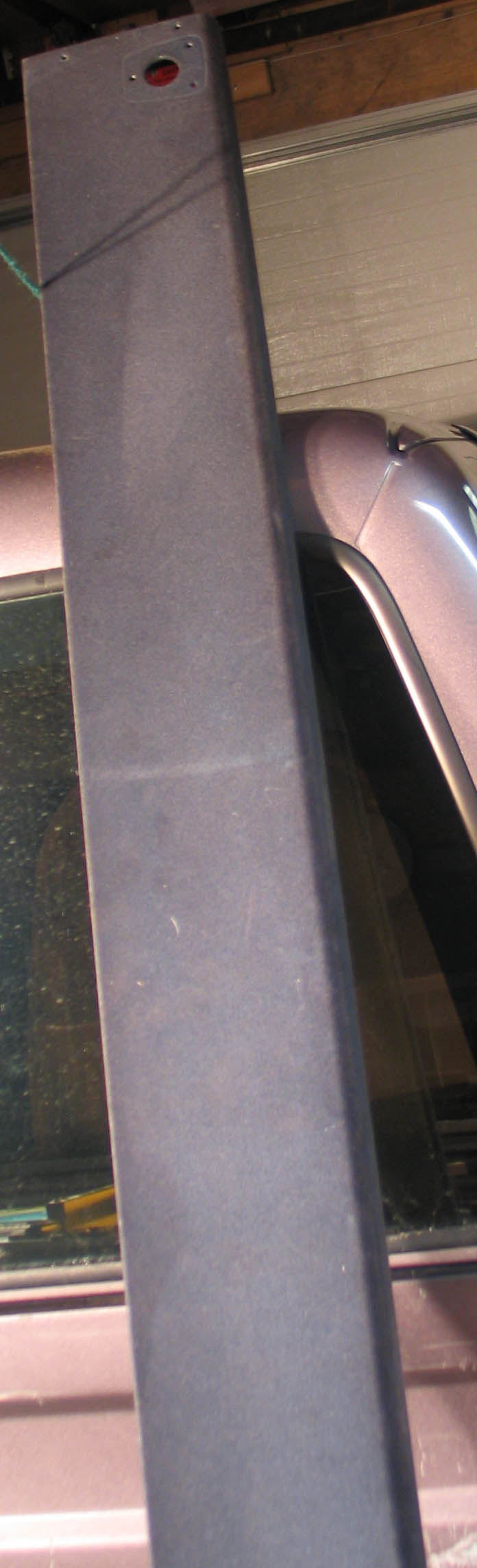 Dark gray visor shelf with a red light and mounting holes