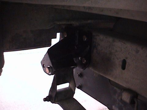 1994 Ford Bronco - This image shows a close-up view of a lift kit component installed on a vehicle's frame and leaf spring assembly.