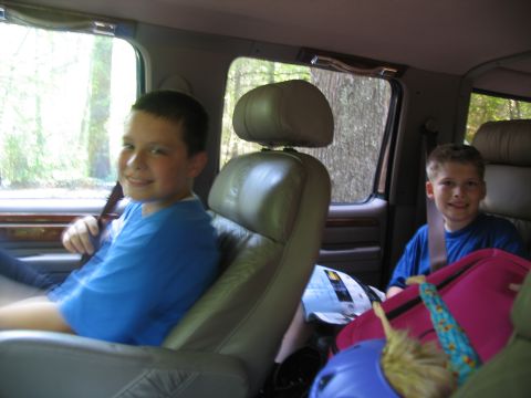 1995 Ford C-150 (Centurion Conversions) - Two boys are riding in the back of a van, looking out the window.
