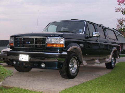 1995 Ford C-150 (Centurion Conversions) - This 1995 Ford C-150 Centurion Conversions SUV is shown in a front 3/4 view, its distinctive grille and dark green paint.