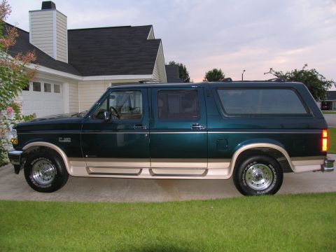 1995 Ford C-150 (Centurion Conversions) - Side profile of a 1995 Ford C-150 (Centurion Conversions) parked on a paved driveway.