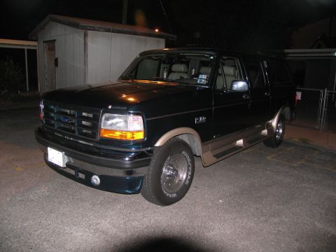 1995 Ford C-150 (Centurion Conversions) - This 1995 Ford C-150 conversion van features a dark green exterior with tan trim and a cap.