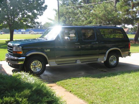1995 Ford C-150 (Centurion Conversions) - Green Ford Bronco Centurion Conversion SUV parked on a paved driveway.